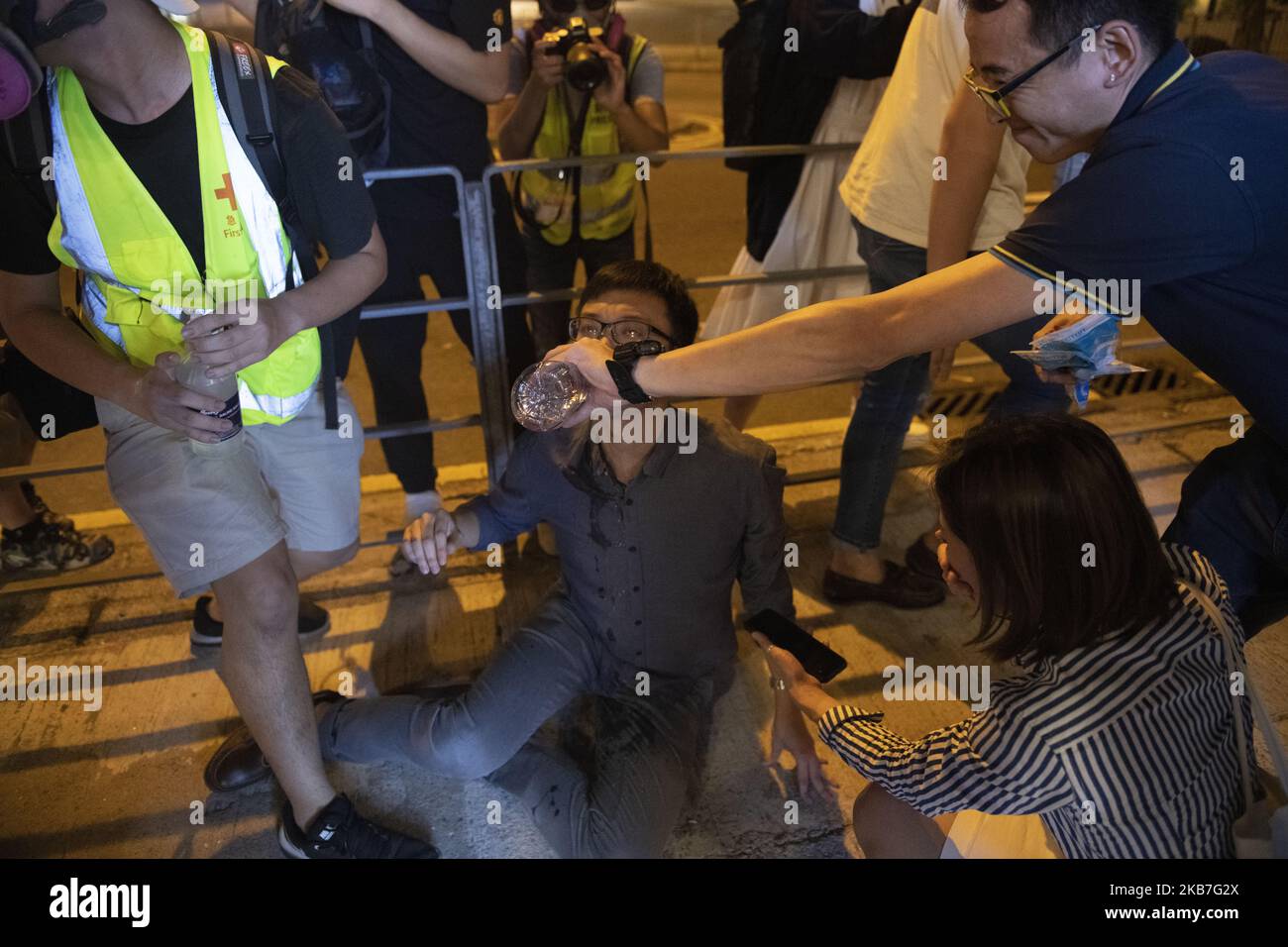 A Man is seen drinking water after inhaling Tear Gas smoke in Tai Koo in Hong Kong on October 3, 2019, Pro- Democracy Protester Have Been Protesting across Hong Kong for the past few months calling for the government to meet their demands including setting up an independent inquiry into police misconduct and abuse of power over the past few months of protest in Hong Kong, Also calling for universal Suffrage (Photo by Vernon Yuen/NurPhoto) Stock Photo