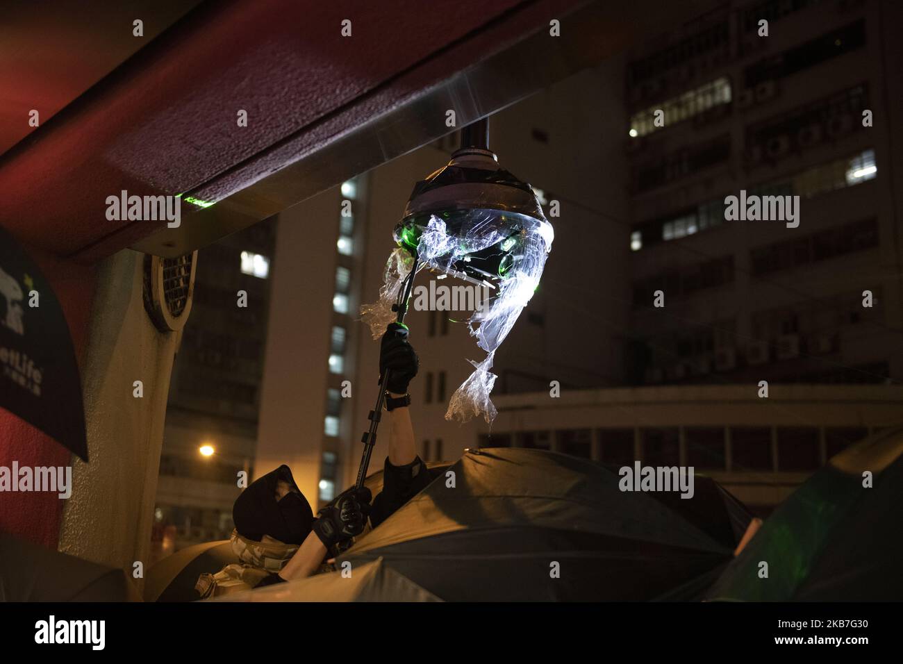 A Protesters is seen destroying a CCTV Camers in an MTR Station Exit in Tai Koo in Hong Kong on October 3, 2019, Pro- Democracy Protester Have Been Protesting across Hong Kong for the past few months calling for the government to meet their demands including setting up an independent inquiry into police misconduct and abuse of power over the past few months of protest in Hong Kong, Also calling for universal Suffrage (Photo by Vernon Yuen/NurPhoto) Stock Photo