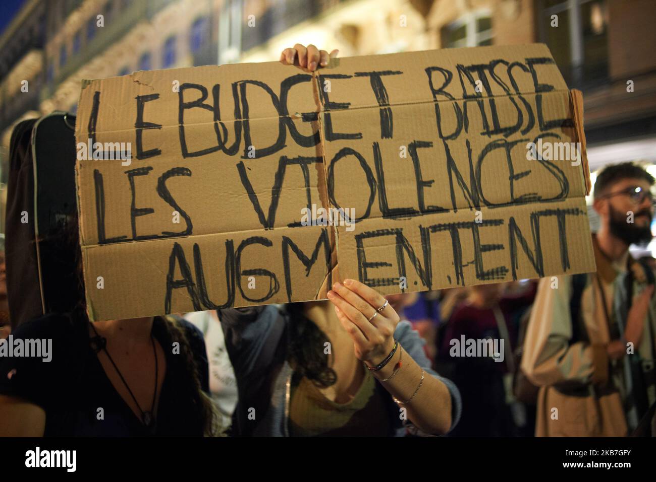 A protester brandishes a placard reading 'Less budget, more violences'. As Edouard Philippe, French Prime Minister, launched a consultation against violence towards women, women organized a march in Toulouse to pay tribute to women victim of murder by their male partner and to ask more meanings to the French government to protect these women beaten by their partner. They call a woman killed by her partner a feminicide (or femicide). To date, 113 women have been killed by their partner in France. Toulouse. France. September 3th 2019. (Photo by Alain Pitton/NurPhoto) Stock Photo