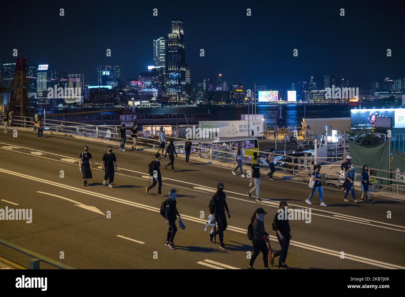 Protesters are seen walking on a road in Hong Kong on October 4, 2019, Hong Kong invoked emergency powers for the first time in more than half a century to ban face masks for protesters after months of unrest, prompting demonstrators to occupy downtown streets and forcing the metro operator to shut down all services late Friday. (Photo by Vernon Yuen/NurPhoto) Stock Photo