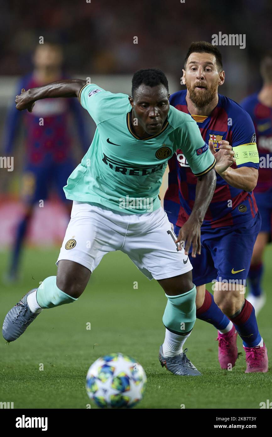 Kwadwo Asamoah of Inter of Milan and Lionel Messi of Barcelona compete for the ball during the UEFA Champions League group F match between FC Barcelona and Inter at Camp Nou on October 2, 2019 in Barcelona, Spain. (Photo by Jose Breton/Pics Action/NurPhoto) Stock Photo