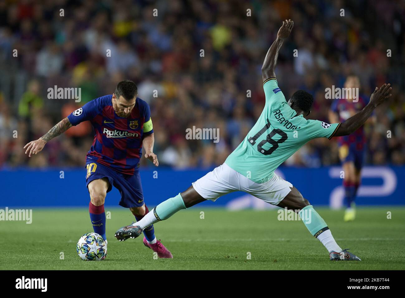 Lionel Messi of Barcelona and Kwadwo Asamoah of Inter of Milan compete for the ball during the UEFA Champions League group F match between FC Barcelona and Inter at Camp Nou on October 2, 2019 in Barcelona, Spain. (Photo by Jose Breton/Pics Action/NurPhoto) Stock Photo