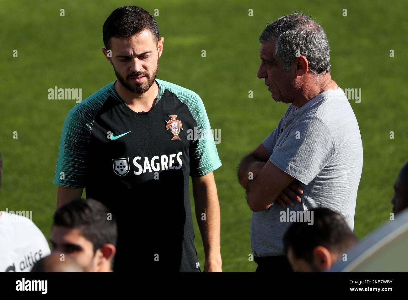 Portugal's forward Bernardo Silva (L) chats with Portugal's head coach Fernando Santos action during a training session at Cidade do Futebol (Football City) training camp in Oeiras, outskirts of Lisbon, Portugal, on October 8, 2019, ahead of the UEFA EURO 2020 qualifier matches against Luxembourg and Ukraine. (Photo by Pedro FiÃºza/NurPhoto) Stock Photo