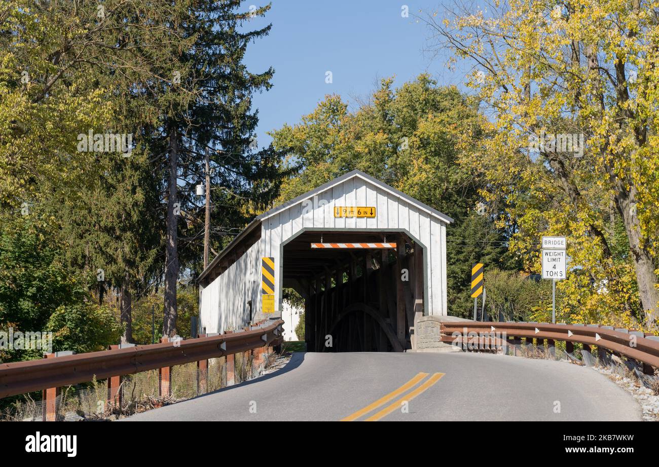 Keller’s Mill Covered Bridge in Autumn, This is a historic white covered bridge in Lancaster County, Pennsylvania Stock Photo