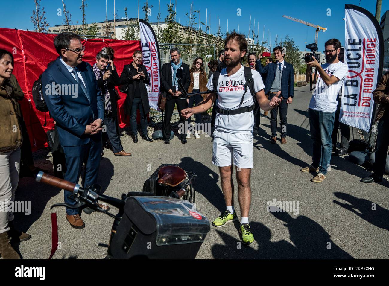 Jeremy Chalon arrives after 1600km by bike as part of the Red Ribbon in Lyon, France, on October 8, 2019. The Red Ribbon Loop is a national AIDS awareness and prevention operation that aims to mobilize elected officials and citizens on global health issues. (Photo by Nicolas Liponne/NurPhoto) Stock Photo