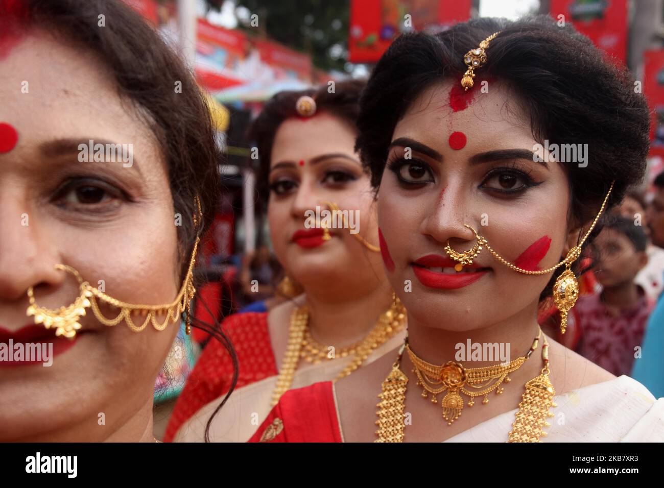 Sindhara Rituals An Indian Hindu devotee smiles as she is smeared with vermillion powder ...