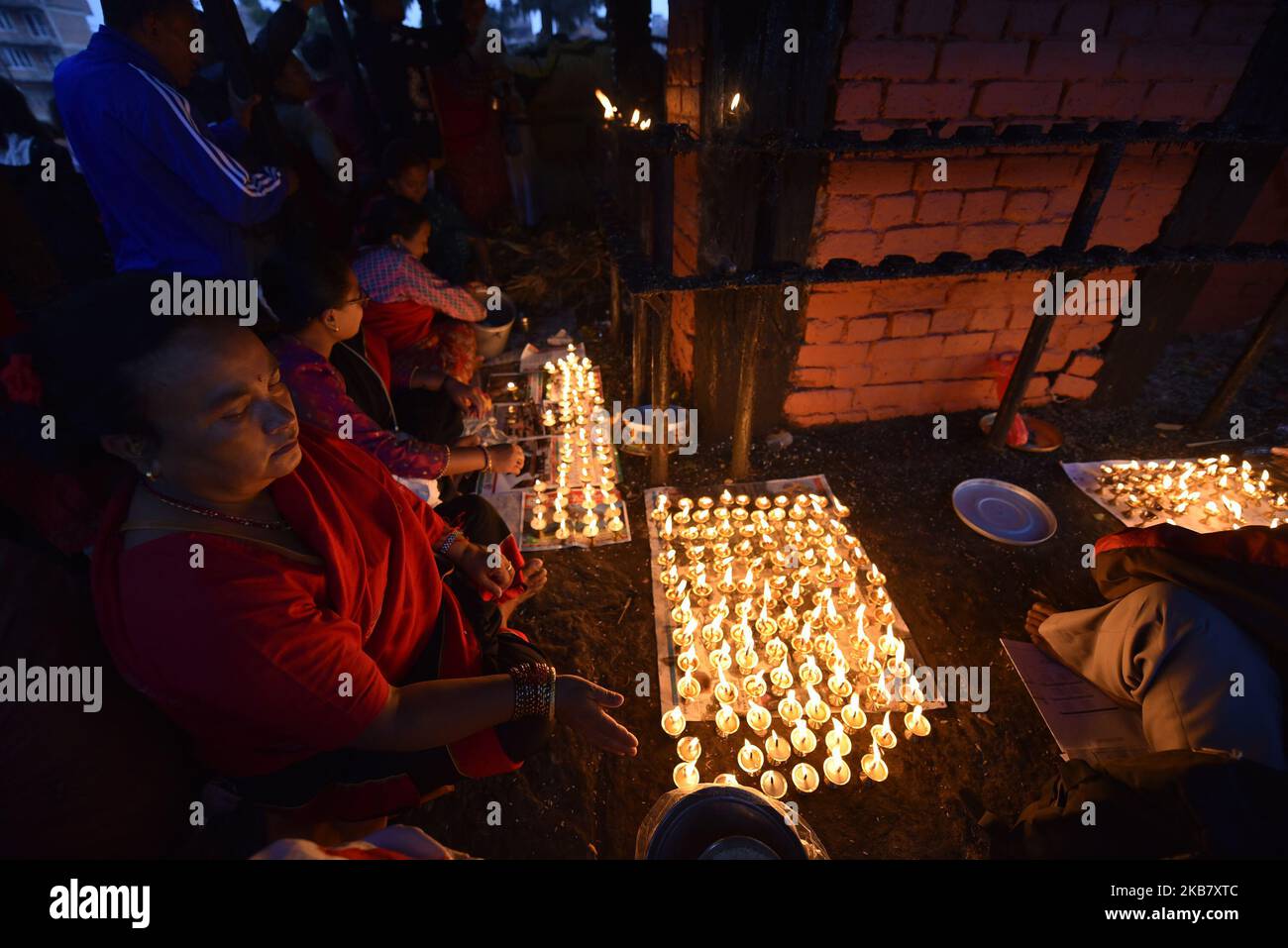A Nepalese devotee hold oil lamps on his body during the tenth day of