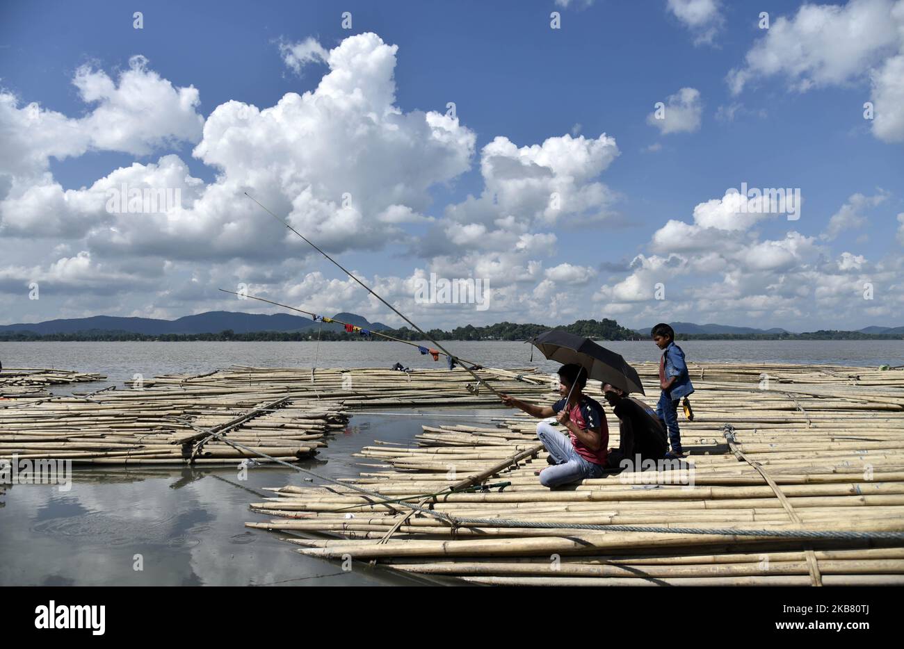 Men fishing in the Brahmaputra river, on a sunny day in Guwahati, Assam, India on October 10