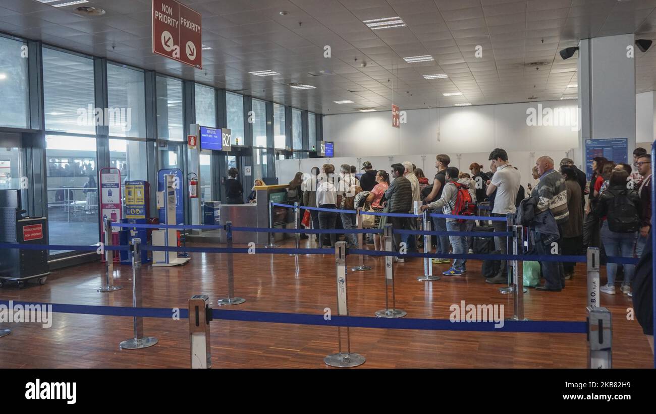 People wait to board at a gate at Milan Bergamo airport in Milan , Italy , 10 October 2019. (Photo by Giannis Alexopoulos/NurPhoto) Stock Photo
