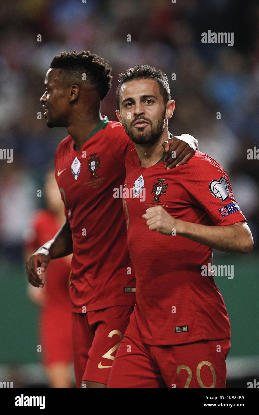 Bernardo Silva of Portugal (R) celebrates his goal with Nelson Semedo of Portugal (L) during the Euro 2020 qualifying match football match between Portugal v Luxembourg, in Lisbon, on October 11, 2019. (Photo by Carlos Palma/NurPhoto) Stock Photo