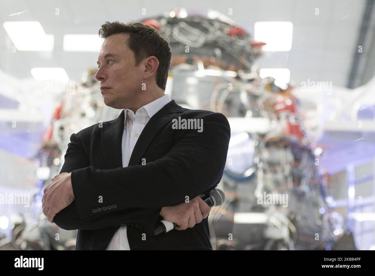 SpaceX Chief Engineer Elon Musk speaks in front of Crew Dragon