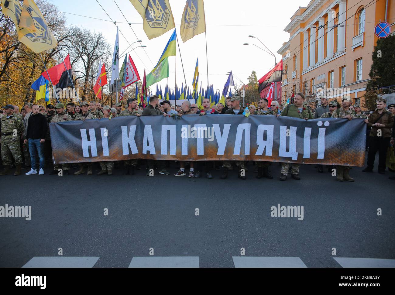 Veterans of Azov battalion carries a banner which says 'No Capitulation'during a rally in Kyiv, Ukraine, October 14, 2019. Several Thousand Ukrainians attend the March Against Capitulation and Surrender of State Interests on October 14, when Ukraine marks the Day of Defender. (Photo by Sergii Kharchenko/NurPhoto) Stock Photo