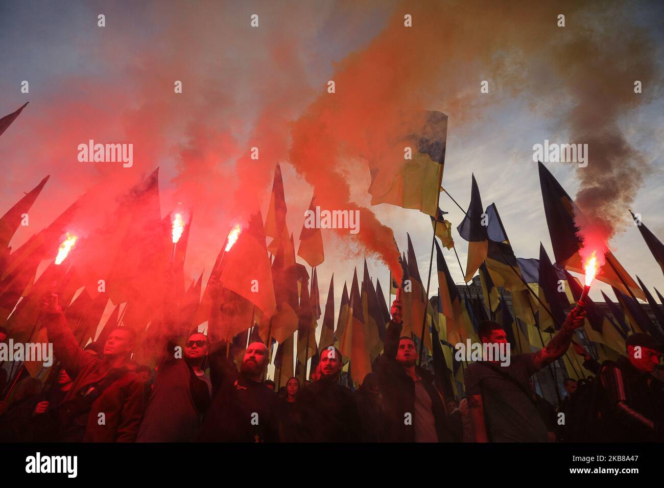 Men in uniforms lit flares during a rally against surrender in Kyiv, Ukraine, October 14, 2019. Several Thousand Ukrainians attend the March Against Capitulation and Surrender of State Interests on October 14, when Ukraine marks the Day of Defender. (Photo by Sergii Kharchenko/NurPhoto) Stock Photo