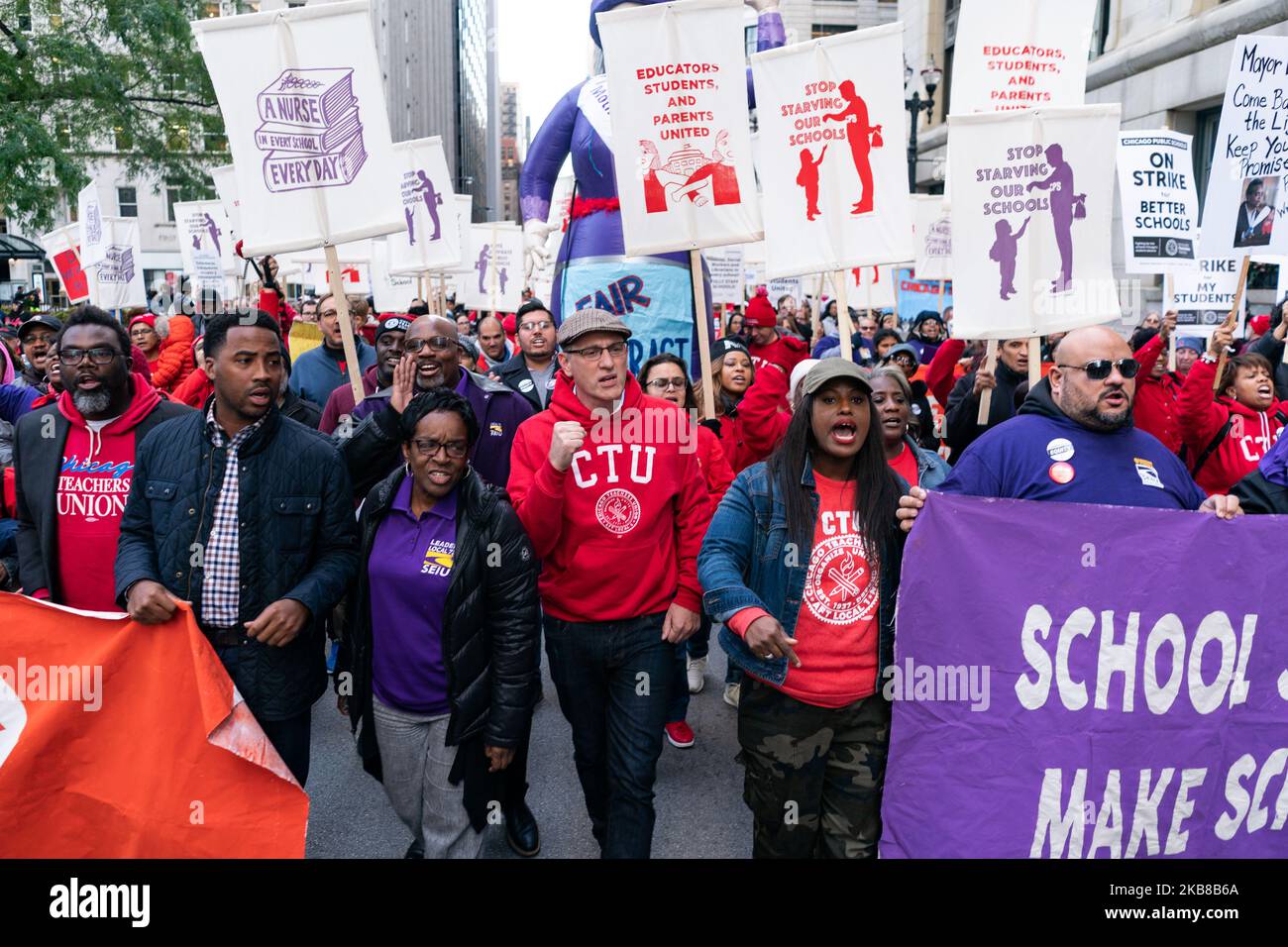 Service Employees International Union (SEIU) President Dian Palmer marches with Chicago Teachers Union President Jesse Sharkey and Vice President Stacy Davis Gates in downtown Chicago on October 14, 2019. CTU and SEIU members, totaling 35,000 workers, are preparing to strike on October 17 if contract negotiations with the city are not finalized. (Photo by Max Herman/NurPhoto) Stock Photo
