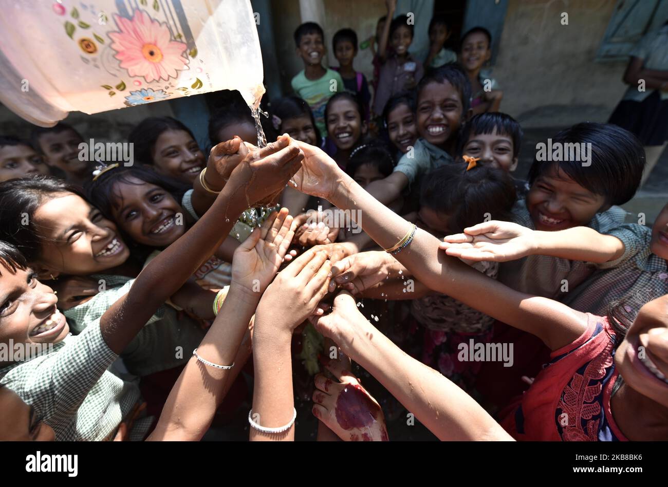 Children wash their hands during an event to mark Global Handwashing Day at a primary school on the outskirt of Guwahati, in Assam, India on Tuesday, October 15, 2019. Global Handwashing Day, celebrated on October 15 every year, aims to educate children washing hands by using soap before eating and after playtime. (Photo by David Talukdar/NurPhoto) Stock Photo