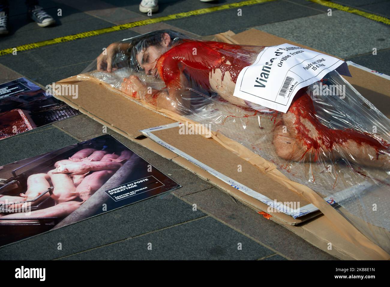 A L214 member covered with false blood in shrink-wrapped tray. Protesters of the association L214 made an happening in Toulouse to raise awareness about meat consumption: some L214 members put themselves in a shrink-wrapped tray and were covered with false blood with a sticker reading 'Human meat, France Origine'. The L214 association became famous for its numerous films made in slaughterhouses. Their films depicted torture and abuse of livestock in some slaughterhouses. Toulouse. France. October 16th 2019. (Photo by Alain Pitton/NurPhoto) Stock Photo