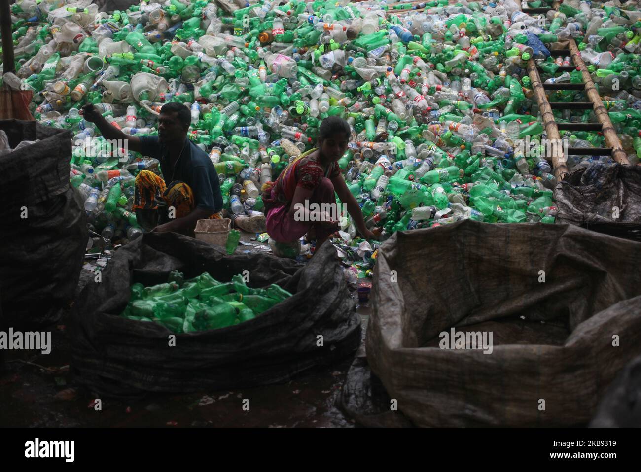 Workers seen working in a plastic bottle recycling factory in Dhaka