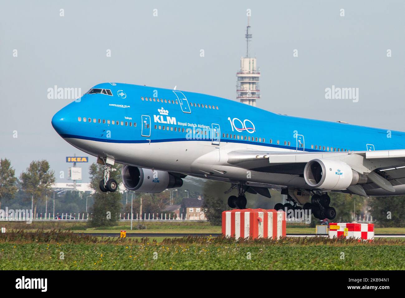 KLM Royal Dutch Airlines Boeing Jumbo Jet 747-400M airplane as seen on final approach landing, touch down and rubber smoke at Polderbaan runway 18R/36L from the landing gear wheels at Amsterdam Schiphol International Airport AMS EHAM in the Netherlands on 16 October 2019. The wide-body, heavy, long-haul 747 or B744 aircraft has the registration PH-BFT, the name Tokyo / City of Tokyo, has a 4x GE CF6-80 engines and a 100 years anniversary logo sticker on the fuselage. The airliner is a mixed passenger and Freight or Combi variant. KLM KL Koninklijke Luchtvaart Maatschappij airline is the flag c Stock Photo