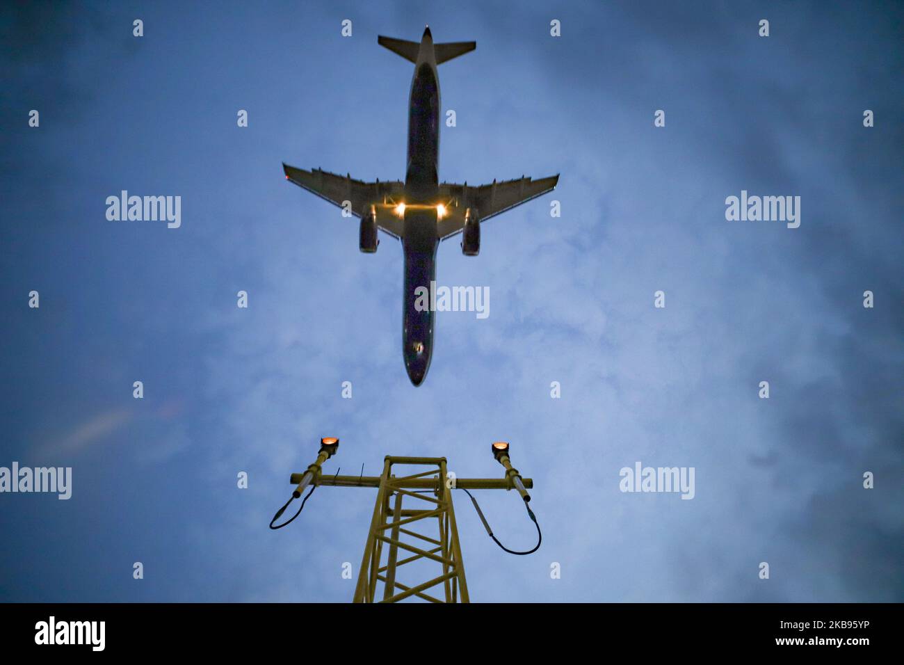 Airplane silhouettes while on final approach landing, during the sunset ...