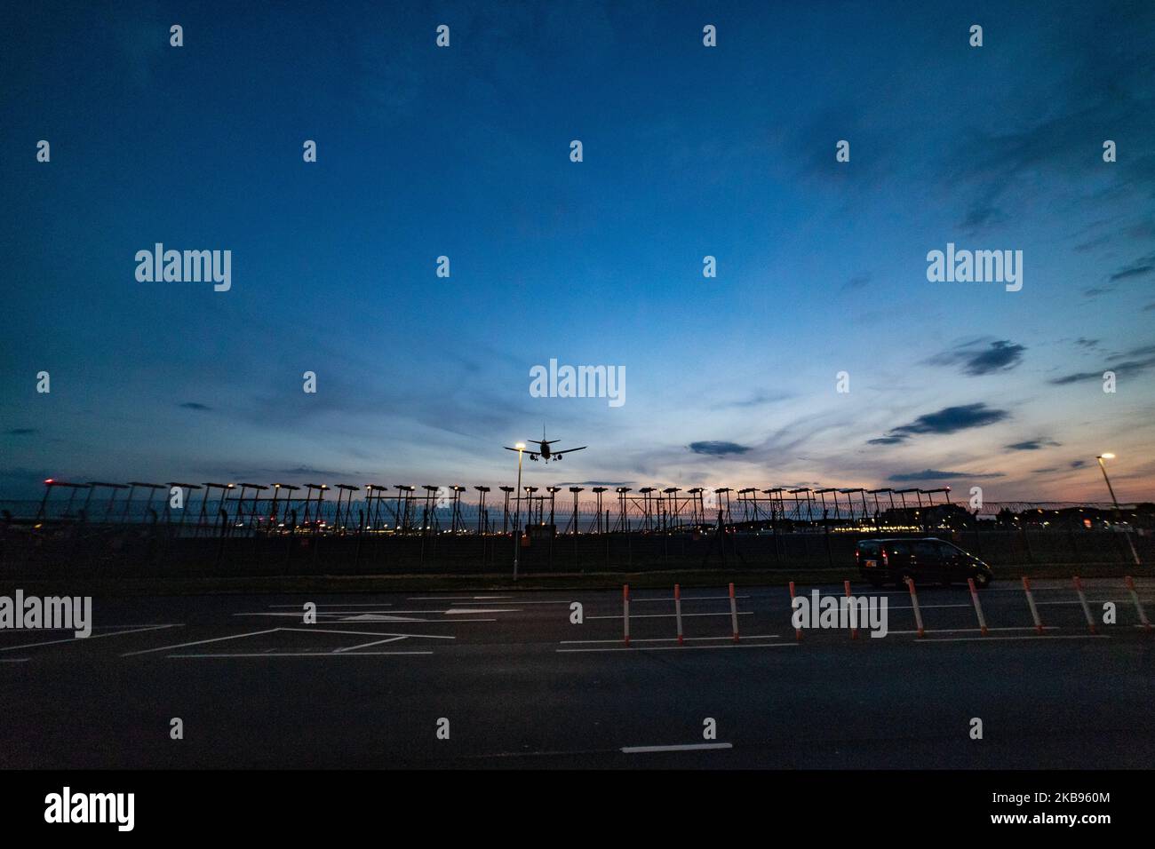 Airplane silhouettes while on final approach landing, during the sunset ...