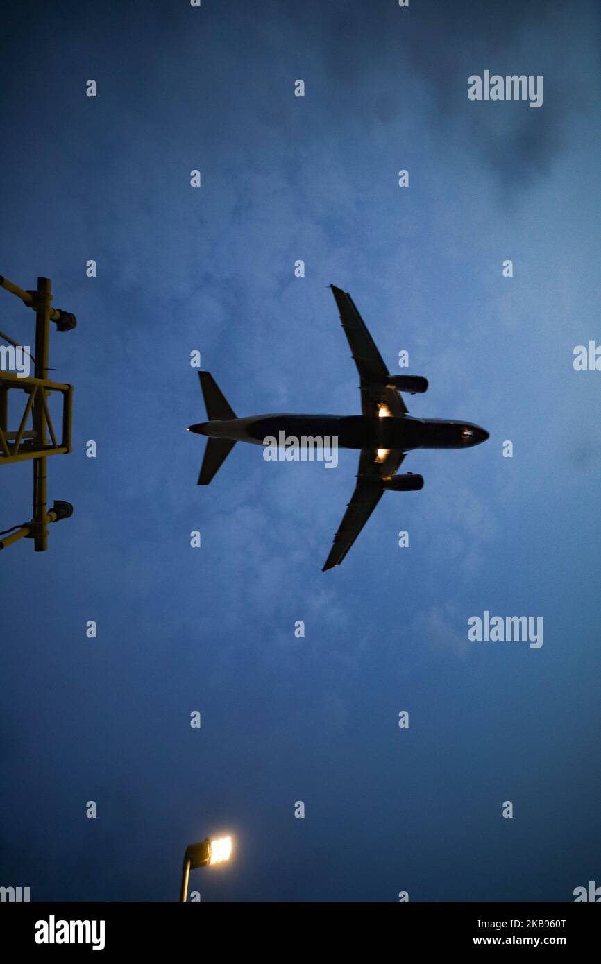 Airplane silhouettes while on final approach landing, during the sunset ...
