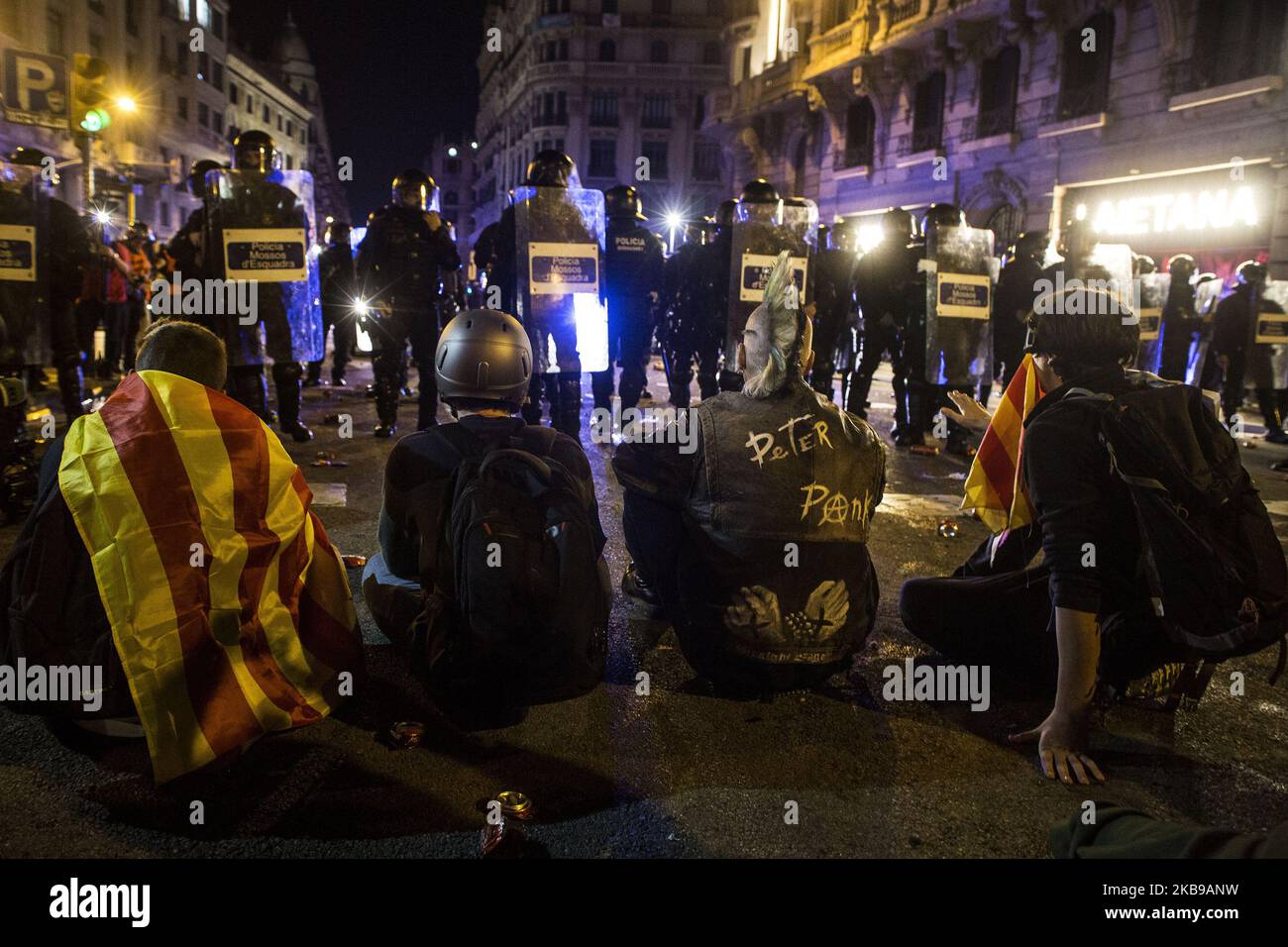 A group of protesters try to resist sitting on the floor. New charges and persecutions with police vans have just dissolved the protesters in the Eixample neighborhood. (Photo by Isidre Garcia Punti/NurPhoto) Stock Photo