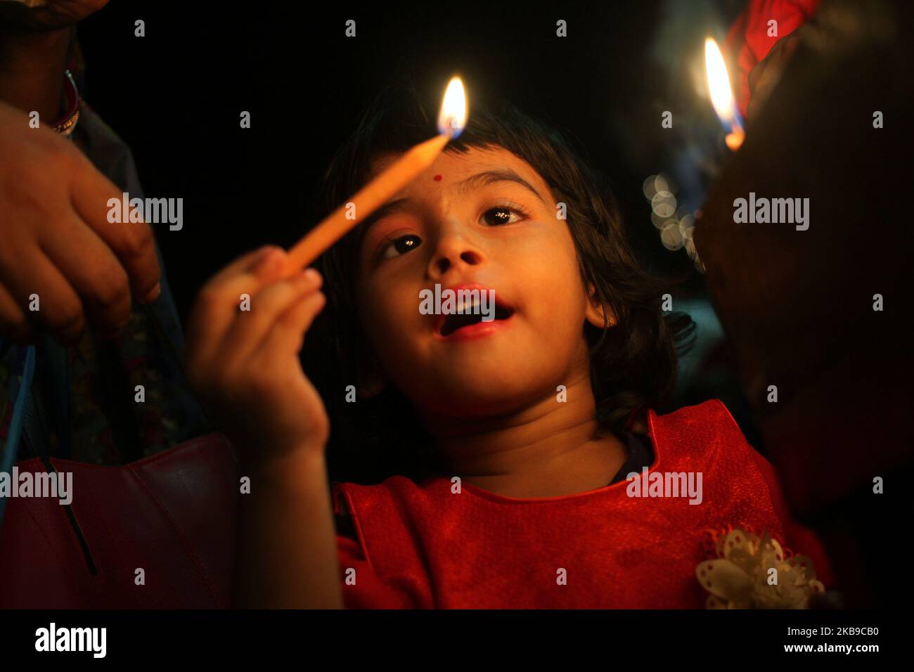 A young girl seen lighting a candle as she came to take part in a
