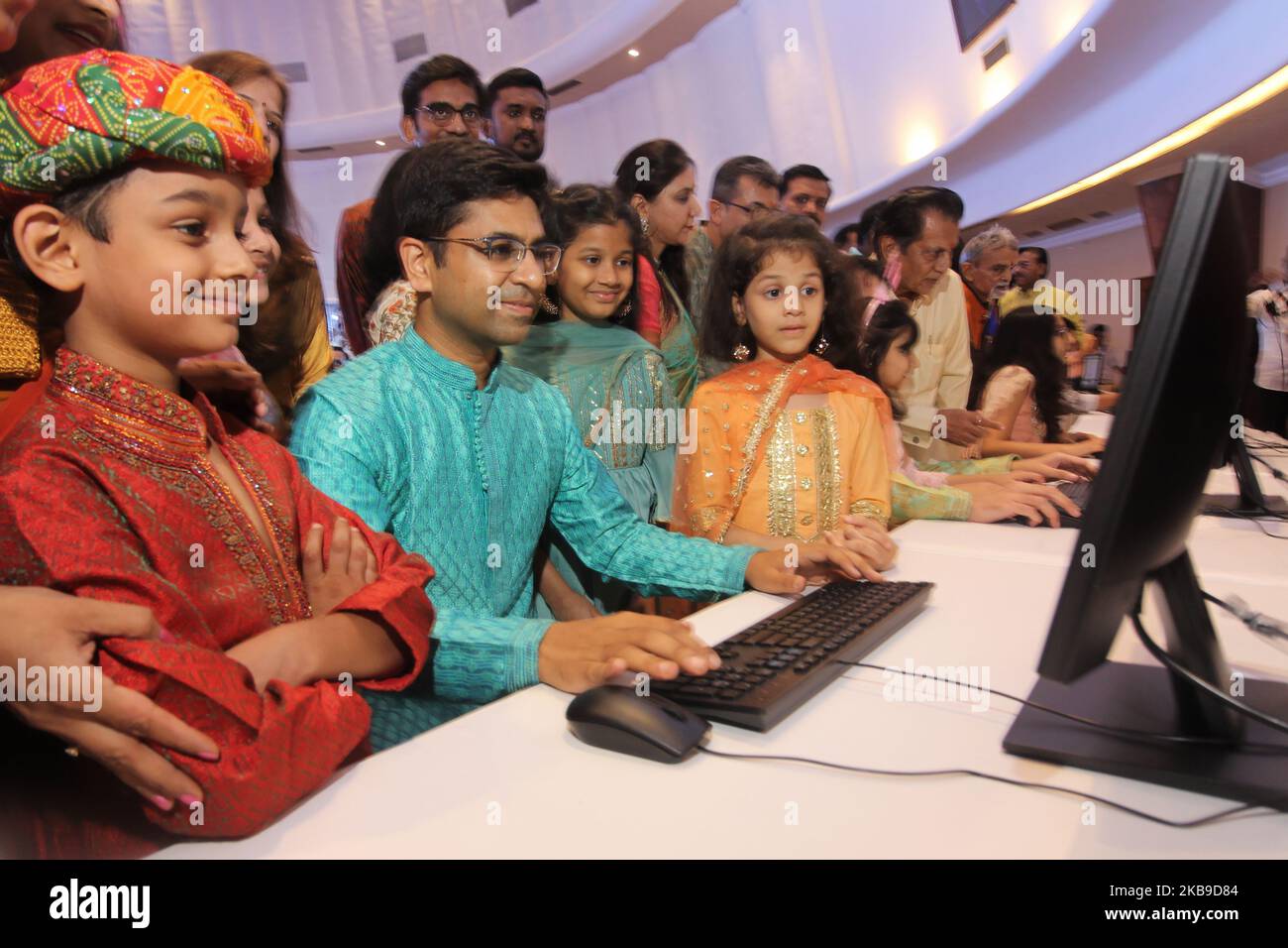 A stockbroker, along with their families, watches the 'Muhurat' trading to mark Diwali festival at the Bombay Stock Exchange (BSE) in Mumbai, India on 27 October 2019. (Photo by Himanshu Bhatt/NurPhoto) Stock Photo