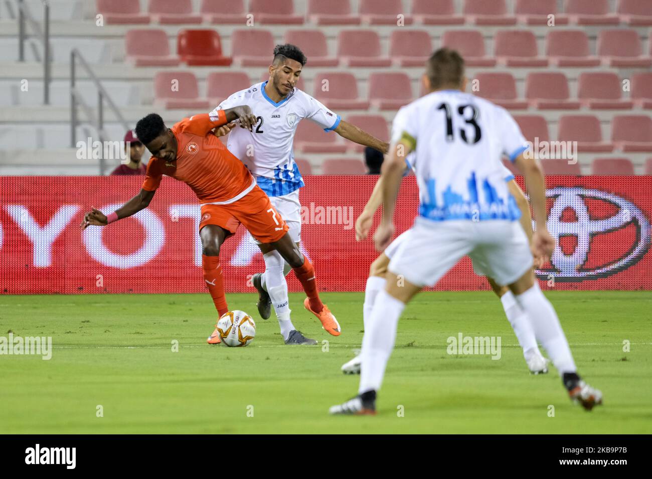 Al Arabi's Musab Kheder is tackled by Mohammed Waed Abdulwahhab Al