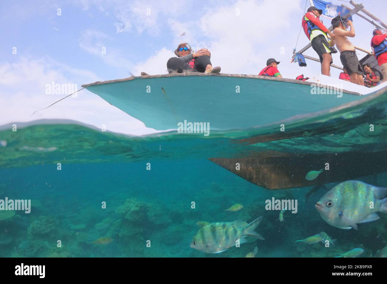 Tourists diving over Coral Reef, at Karimunjawa, a popular beach and ...