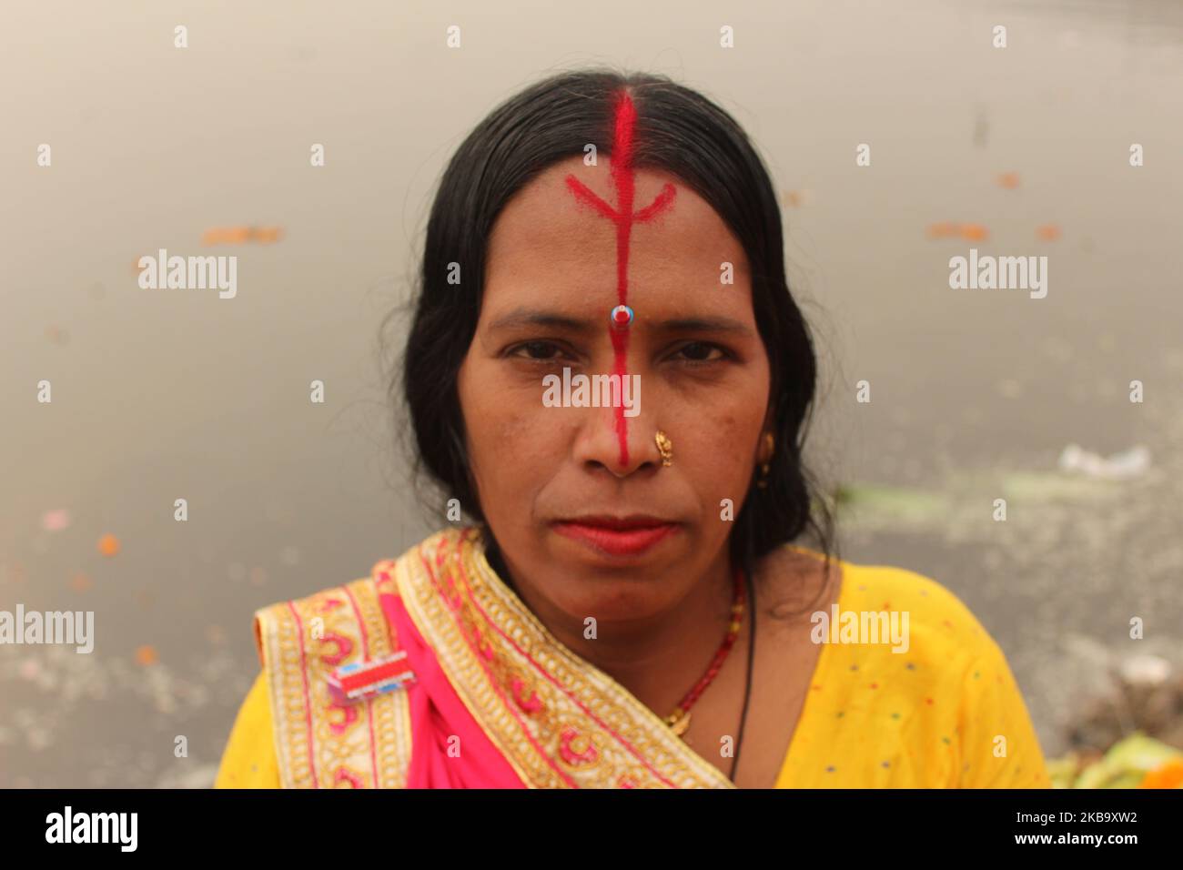 A Hindu devotee is seen during rituals and worshipping the Sun god along the banks of Yamuna River during the religious Hindu festival of Chhath Puja in New Delhi on November 13, 2018. The rituals involve taking dips in rivers or water bodies, strict fasting, standing and offering prayers in water, facing the sun for long periods and also offering Prasad to the sun at sunrise and sunset. (Photo by Mayank Makhija/NurPhoto) Stock Photo