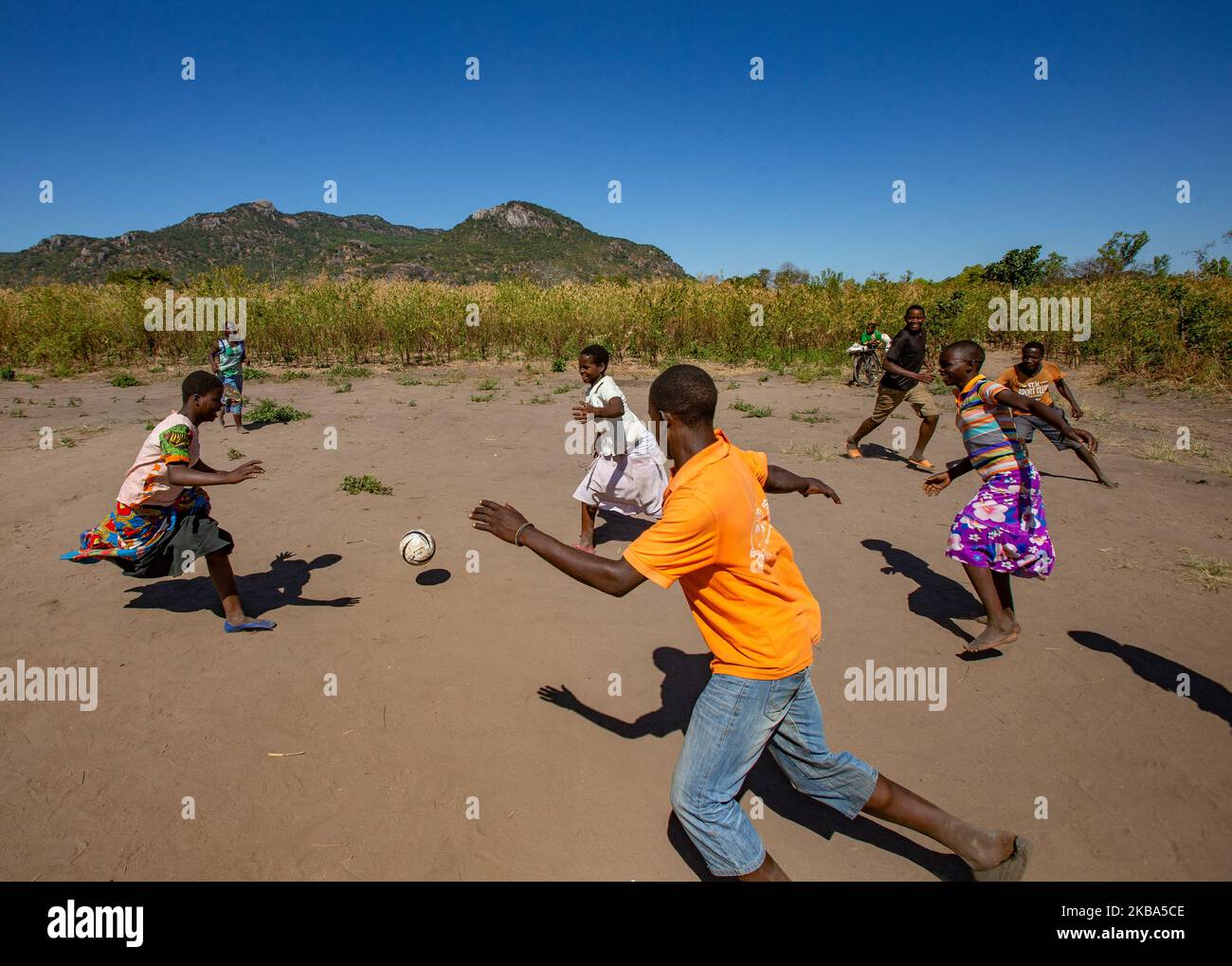 Children playing football in rural hi-res stock photography and images ...