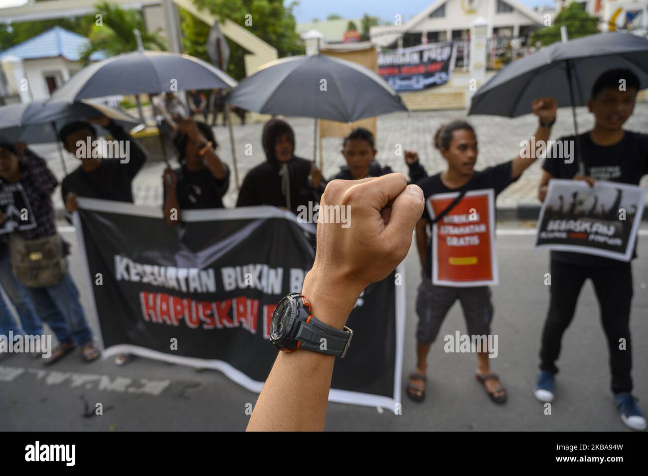 Humanitarian activists carry banners at the Kamisan Action in front of the Central Sulawesi House of Representatives Office in Palu, Central Sulawesi, Indonesia on November 7, 2019. The 16th Kamisan Action this time carries the theme of health and demands to the government so that the state can attend to any public health issues and reject the increase in health insurance contributions managed by the state because they are considered burdening the people. (Photo by Basri Marzuki/NurPhoto) Stock Photo