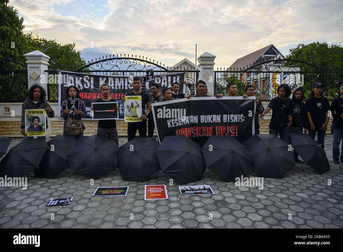 Humanitarian activists carry banners at the Kamisan Action in front of the Central Sulawesi House of Representatives Office in Palu, Central Sulawesi, Indonesia on November 7, 2019. The 16th Kamisan Action this time carries the theme of health and demands to the government so that the state can attend to any public health issues and reject the increase in health insurance contributions managed by the state because they are considered burdening the people. (Photo by Basri Marzuki/NurPhoto) Stock Photo