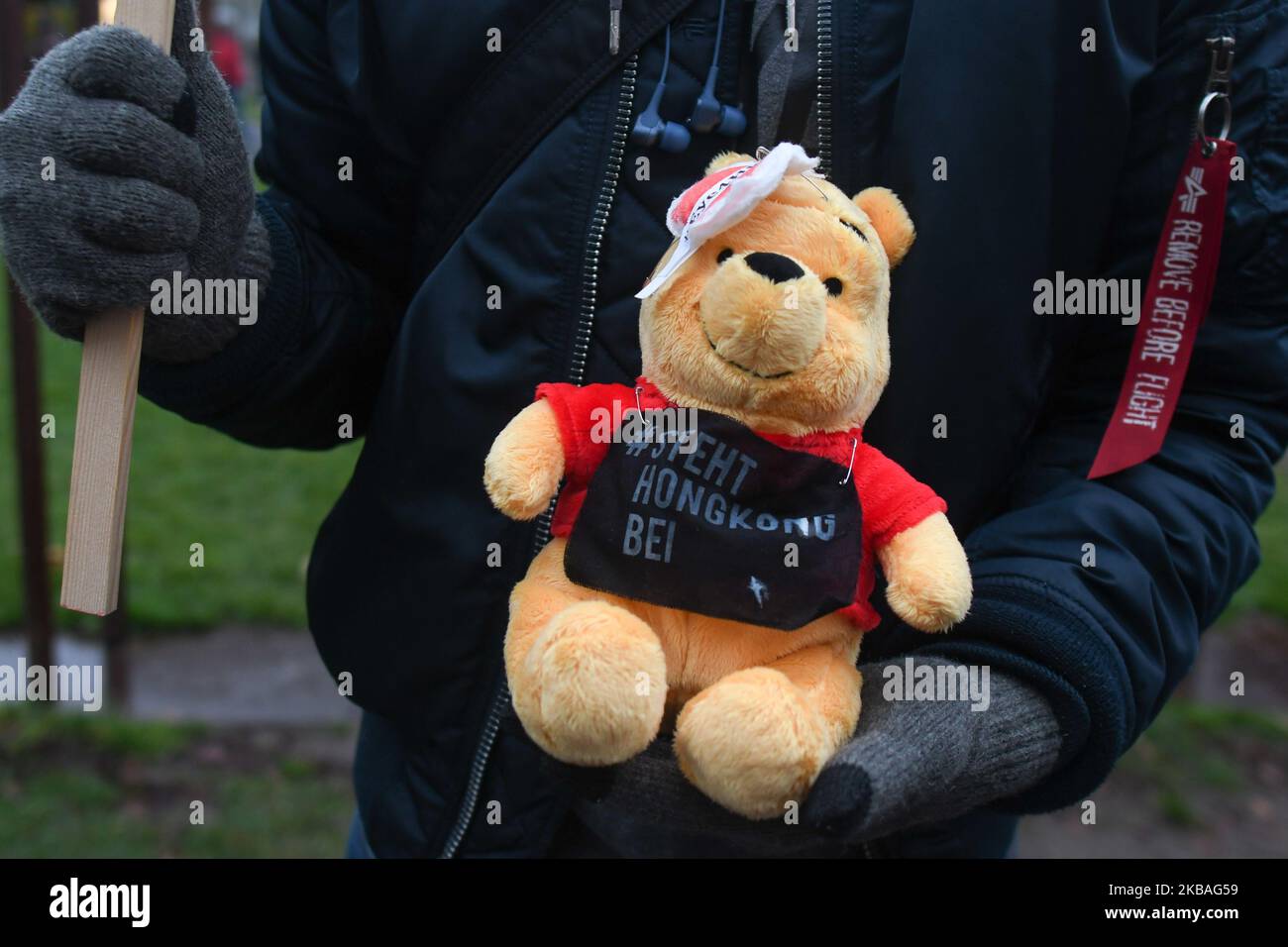 An activist holds a Winnie-the-Pooh teddy bear during a protest in support of pro-democracy demonstrations in Hong Kong at a spot where the Berlin Wall once stood at Bernauer Strasse on the 30th anniversary of the fall of the Berlin Wall. Chinese internet users have joked that Chinese President Xi Jinping resembles the talking bear, leading the country's censors to scrub online references to the character. On Saturday, November 9, 2019, in Berlin, Germany. (Photo by Artur Widak/NurPhoto) Stock Photo