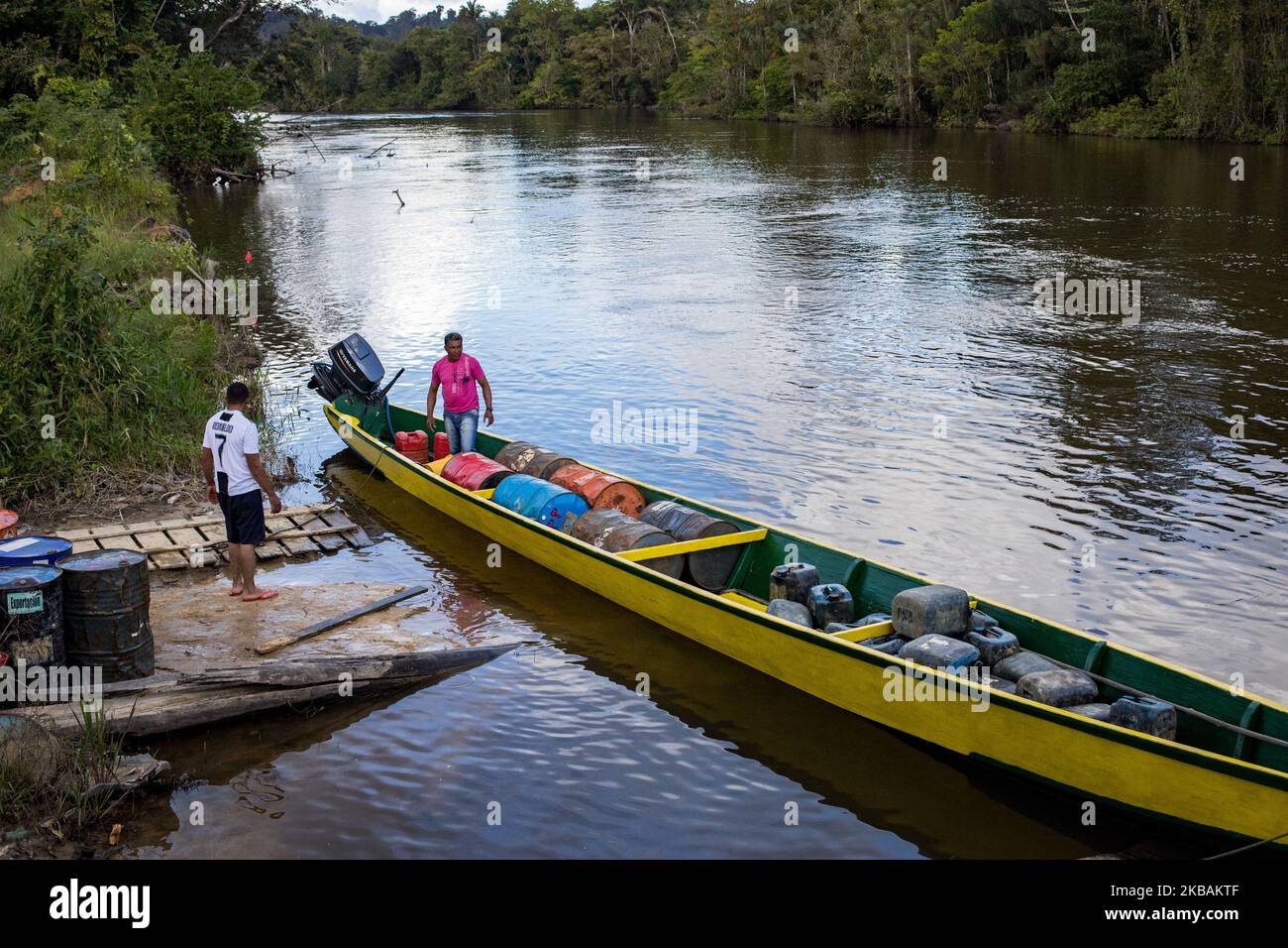 Maripasoula, France, June 29, 2019. A Brazilian gold digger loads his  pirogue in the Chinese village of Yalopassi along the Maroni River on the  Suriname side, a few minutes by pirogue from