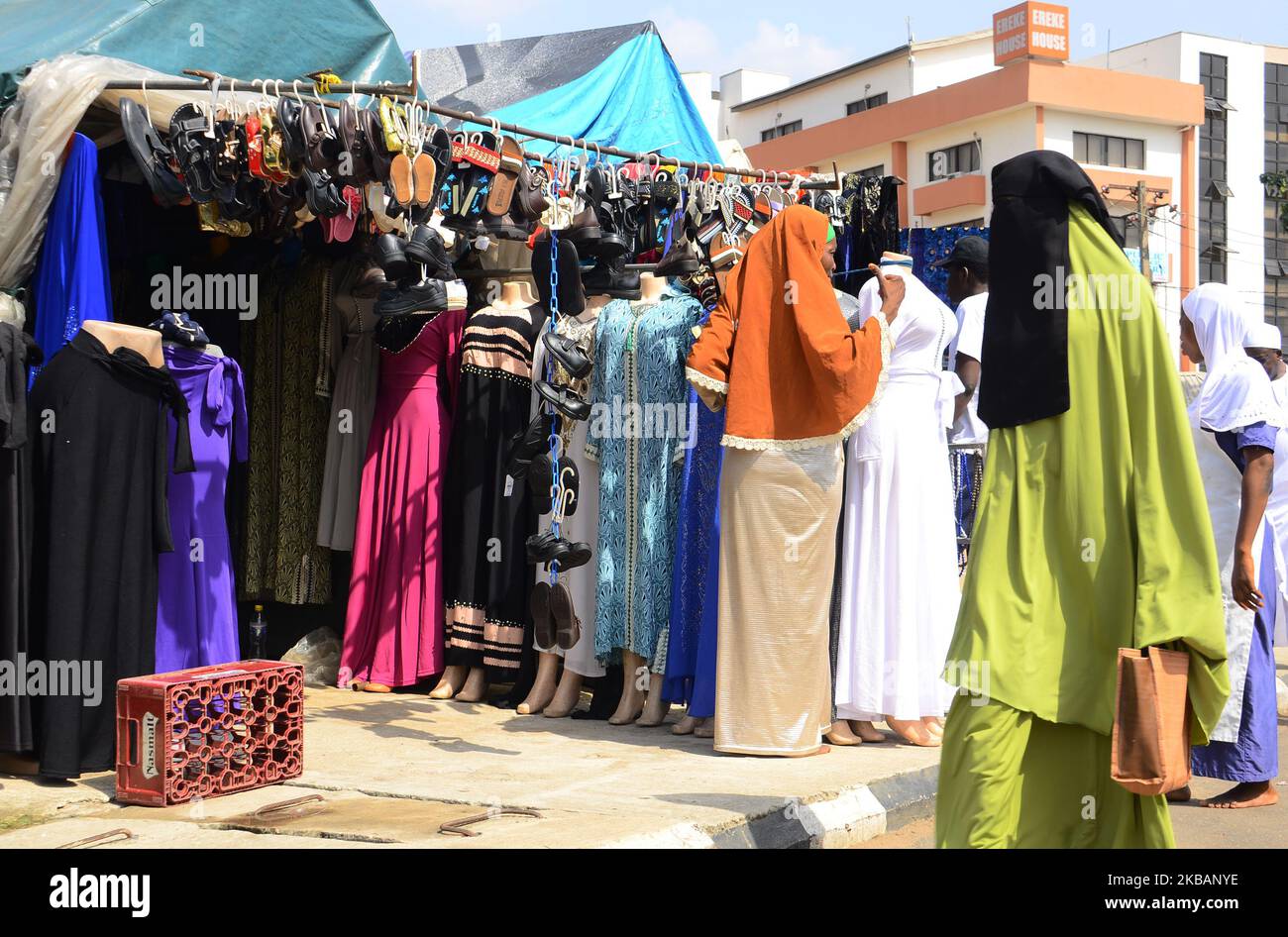 Muslim shoppers pass a popular shop selling Islamic wears and Asian clothing in Alausa business district Area in Lagos, Nigeria on 10 November 2019 to celebrating Eid el Maulud. Eid el Maulud is the birthday of the Holy Prophet Muhammad, the day ia marked every 12th of Rabi'ul Awwal of the Islamic calendar. The teaching of Islam is centered on belief in God, devotion and service to humanity. (Photo by Olukayode Jaiyeola/NurPhoto) Stock Photo