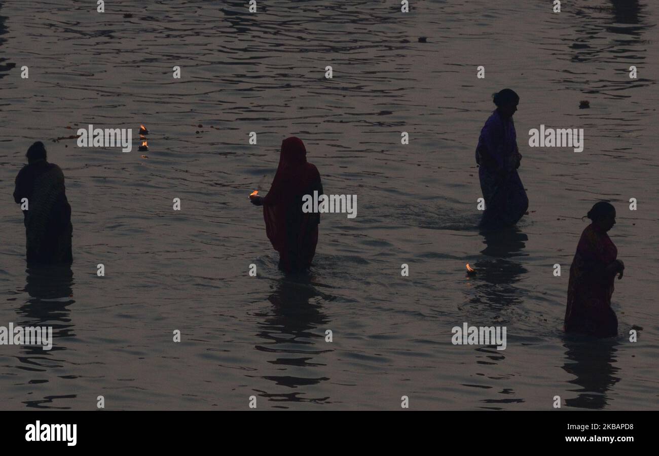 Indian devotees offer rituals and take a holy dip in Saryu river on the