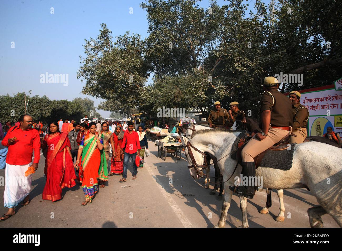 Indian devotees return after taking a holy dip in Saryu river on the