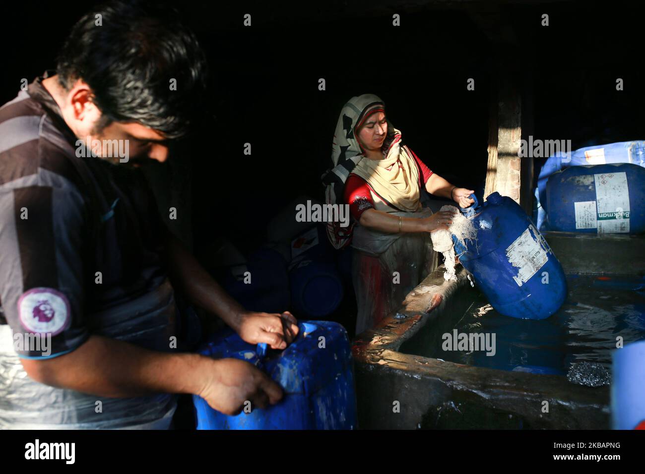 Bangladeshi day labors working at a plastic recycle factory in Dhaka on November 11, 2019