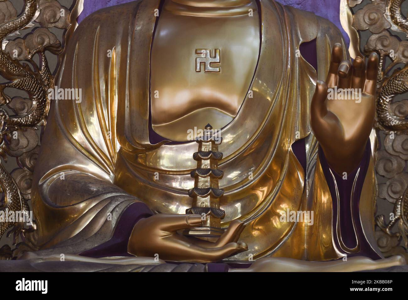 A view of Budda statue with a symbol of swastika, seen inside the Putuo Temple. Swastika is considered to symbolize the auspicious footprints of the Buddha. It is an aniconic symbol for the Buddha in many parts of Asia. The shape symbolizes eternal cycling, a theme found in samsara doctrine of Buddhism. On Friday, October 20, 2019, in Nongla Scenic Area, Mashan County, Guangxi Region, China. (Photo by Artur Widak/NurPhoto) Stock Photo