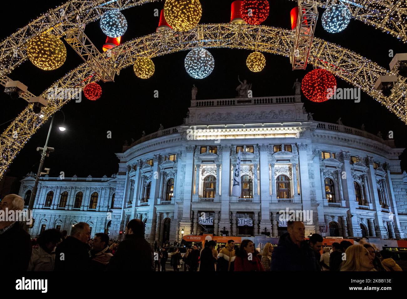Visitors enjoy Christmas lights and small outdoor stands with souvenirs