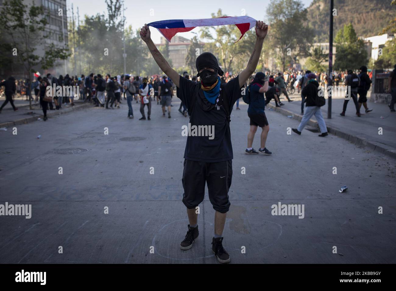 A demonstrator waves a Chile flag during a protest against Chile's government in Santiago, Chile October 31, 2019. (Photo by Jeremias Gonzalez/NurPhoto) Stock Photo