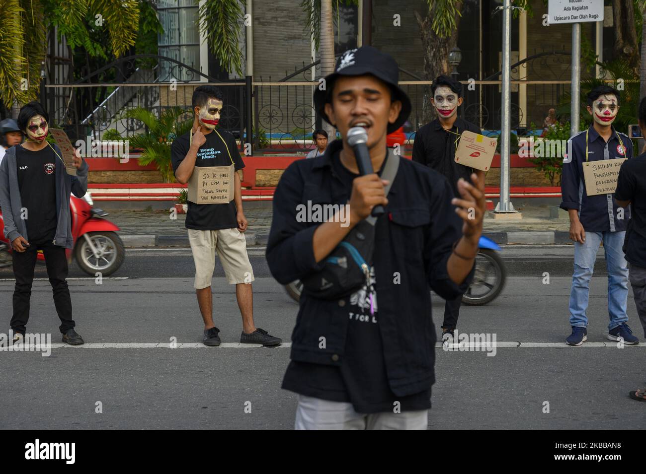 Humanitarian activists put on their faces and carried pamphlets when they held the Kamisan Action in front of the Central Sulawesi House of Representatives Office in Palu, Central Sulawesi, Indonesia on November 21, 2019. This 18th action carried the theme of Mining and stated that it refused to revise the Mineral and Coal Law . They also demanded that the government review the permit granted to PT Citra Palu Mineral to explore gold mining in Poboya, Palu City next year. (Photo by Basri Marzuki/NurPhoto) Stock Photo