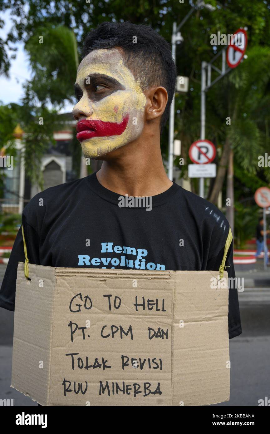 A humanitarian activist put on their faces and carried pamphlets when they held the Kamisan Action in front of the Central Sulawesi House of Representatives Office in Palu, Central Sulawesi, Indonesia on November 21, 2019. This 18th action carried the theme of Mining and stated that it refused to revise the Mineral and Coal Law . They also demanded that the government review the permit granted to PT Citra Palu Mineral to explore gold mining in Poboya, Palu City next year. (Photo by Basri Marzuki/NurPhoto) Stock Photo