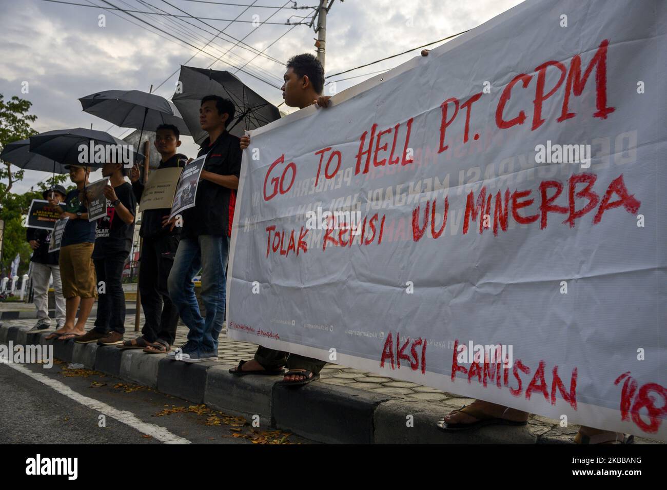 Humanitarian activists carry banners when holding the Kamisan Action in front of the Central Sulawesi House of Representatives Office in Palu, Central Sulawesi, Indonesia on November 21, 2019. This 18th action carried the theme of Mining and stated that it refused to revise the Mineral and Coal Law . They also demanded that the government review the permit granted to PT Citra Palu Mineral to explore gold mining in Poboya, Palu City next year. (Photo by Basri Marzuki/NurPhoto) Stock Photo