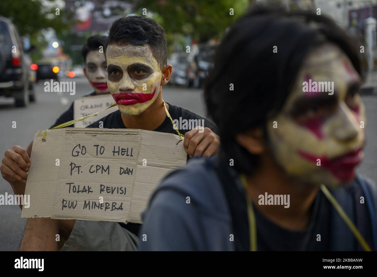 Humanitarian activists put on their faces and carried pamphlets when they held the Kamisan Action in front of the Central Sulawesi House of Representatives Office in Palu, Central Sulawesi, Indonesia on November 21, 2019. This 18th action carried the theme of Mining and stated that it refused to revise the Mineral and Coal Law . They also demanded that the government review the permit granted to PT Citra Palu Mineral to explore gold mining in Poboya, Palu City next year. (Photo by Basri Marzuki/NurPhoto) Stock Photo