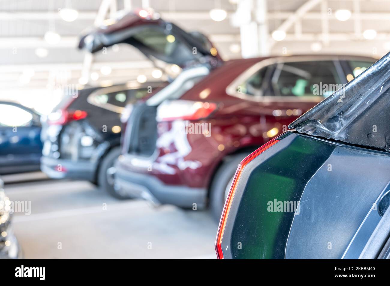 Open truck at a car rental return center where rows of vehicles are
