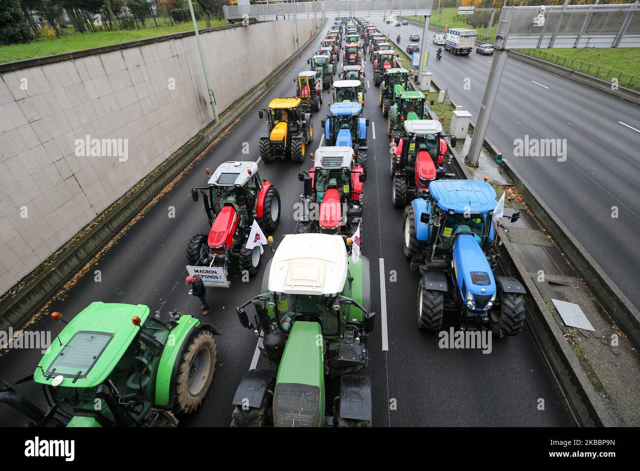 French farmers steer their tractors on The Parisian ring road (Peripherique) at Porte Dauphine in Paris on November 27, 2019, during a protest against government policies. Hundreds of French farmers descended on Paris by tractor to protest the struggles of the farming community and put pressure on supermarket chains to pay them more for their produce. Some 340 kilometres (210 miles) of tailbacks were reported during rush hour in Paris as convoys of tractors snarled traffic along the main roads into the capital. (Photo by Michel Stoupak/NurPhoto) Stock Photo