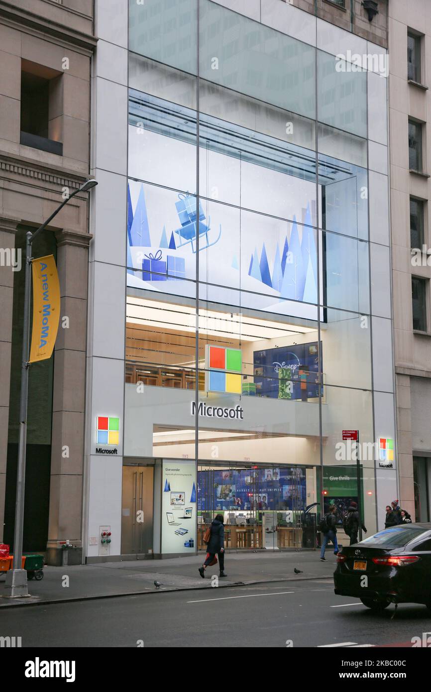 People walk past a Microsoft store entrance with the company's logo on top in midtown Manhattan at the 5th avenue in New York City, US, on 11 November 2019. Microsoft Corporation is world's largest software maker dominant in PC operating system Microsoft Windows, office applications, web browser and communication market. (Photo by Nicolas Economou/NurPhoto) Stock Photo